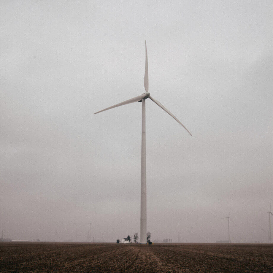 A single wind turbine in a middle of a field